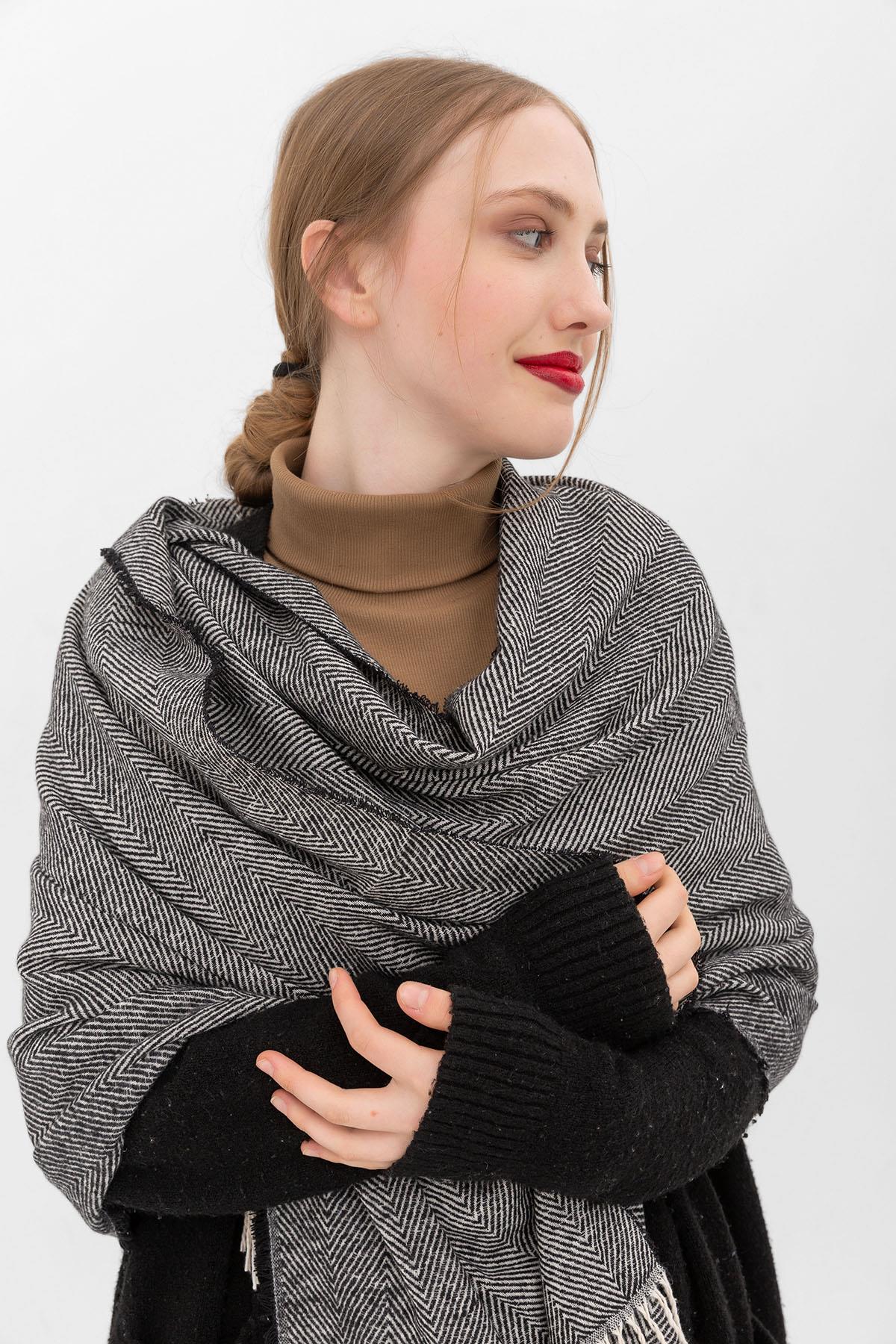 A model wears NSV10801 - Soft Textured Tasseled Thick Shoulder Shawl - Black, wholesale Shawl of Nesvay to display at Lonca