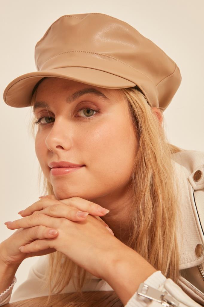 A model wears NSV11193 - Leather Cap Hat - Beige, wholesale Hat of Nesvay to display at Lonca