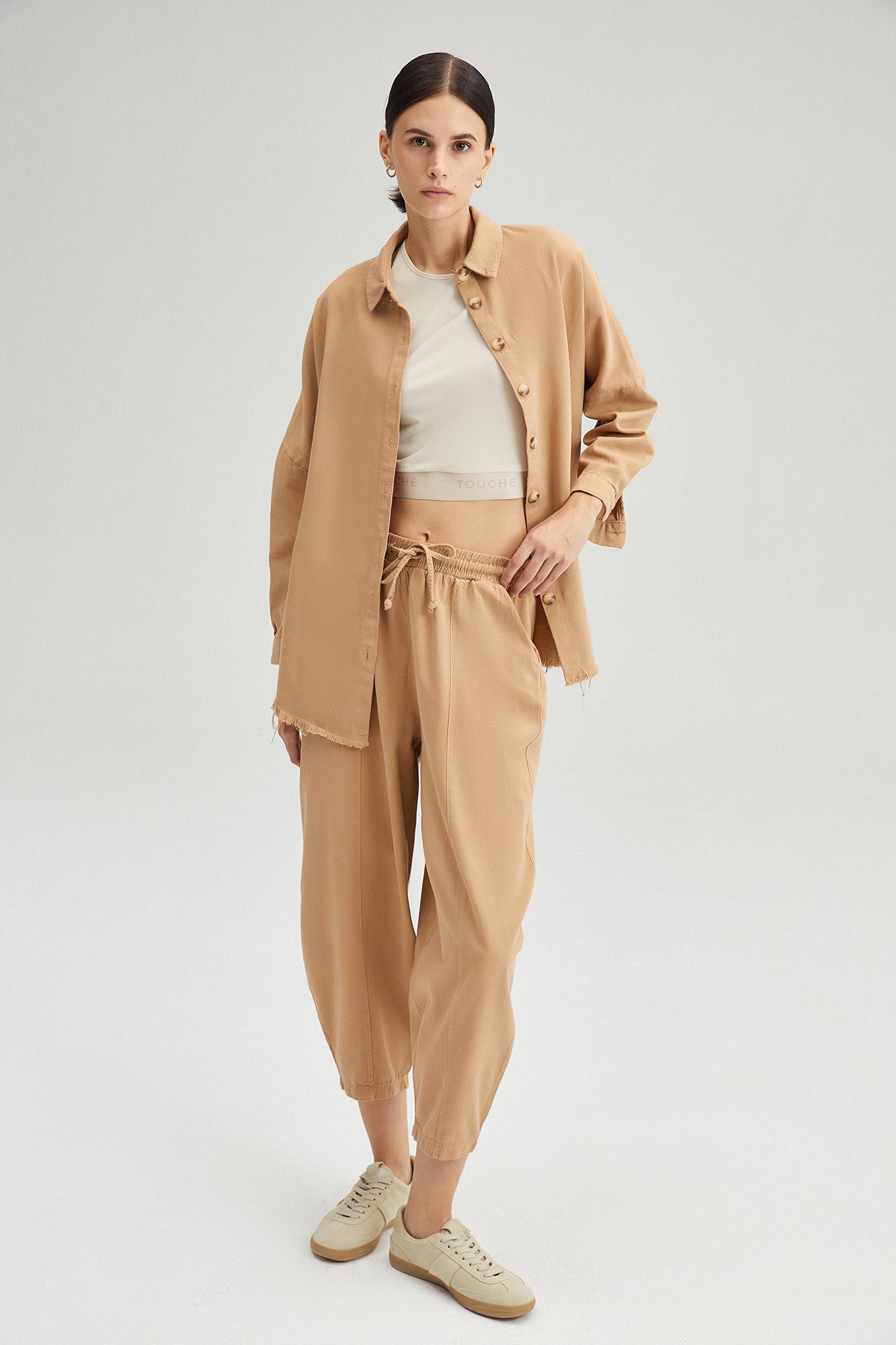 A model wears TOU11414 - Shirt Trousers Gabardine Set - Beige, wholesale Suit of Touche Prive to display at Lonca