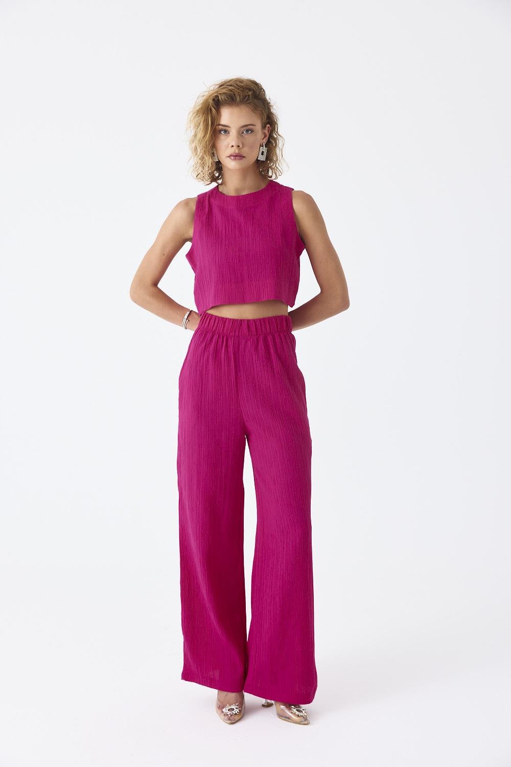 A model wears TBU11772 - Zero Sleeve Blouse And Pants Women's Suit - Fuchsia, wholesale Suit of Tuba Butik to display at Lonca